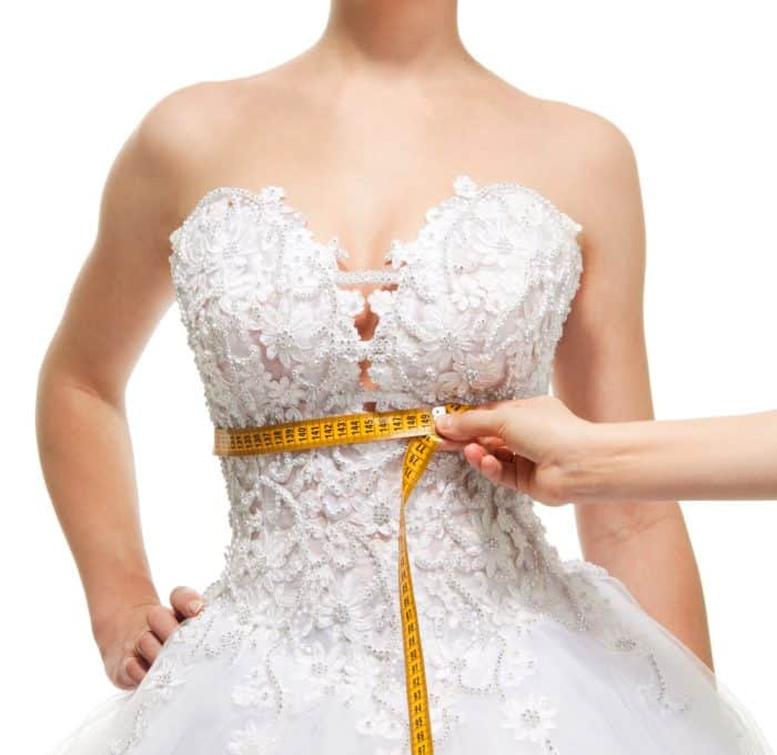 Bride's waist being measured after laser fat removal by Emerald Laser