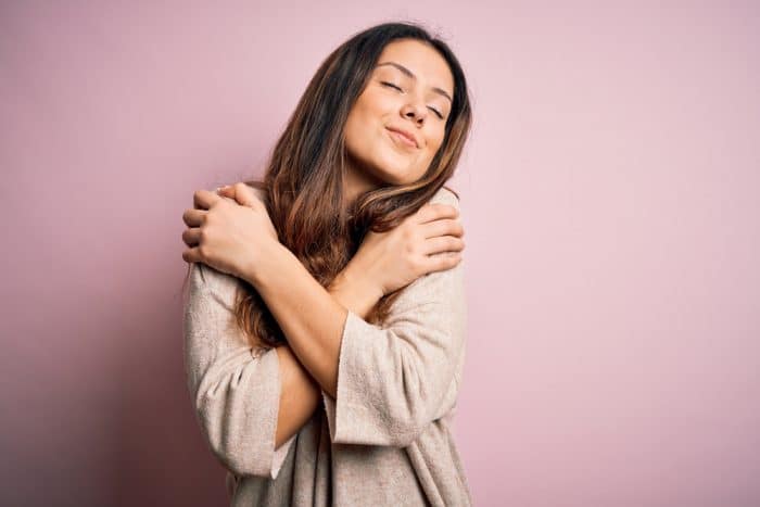 woman crossing her arms with an extremely satisfied expression on her face