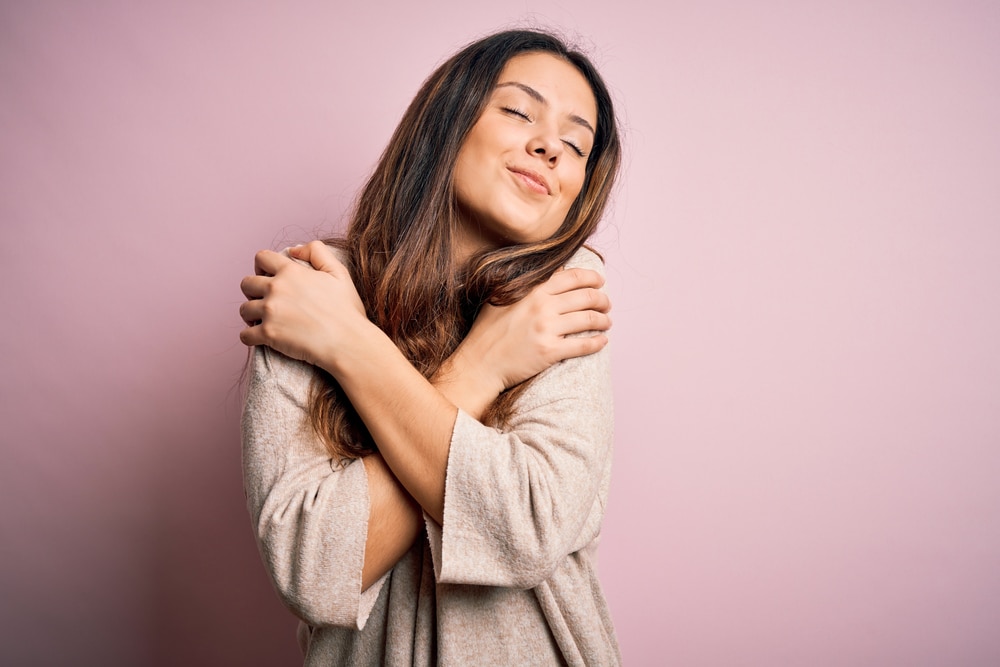 woman crossing her arms with an extremely satisfied expression on her face