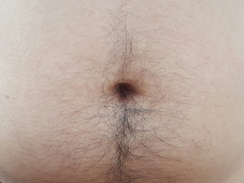 Close up of a man's belly button and upper pubic fat