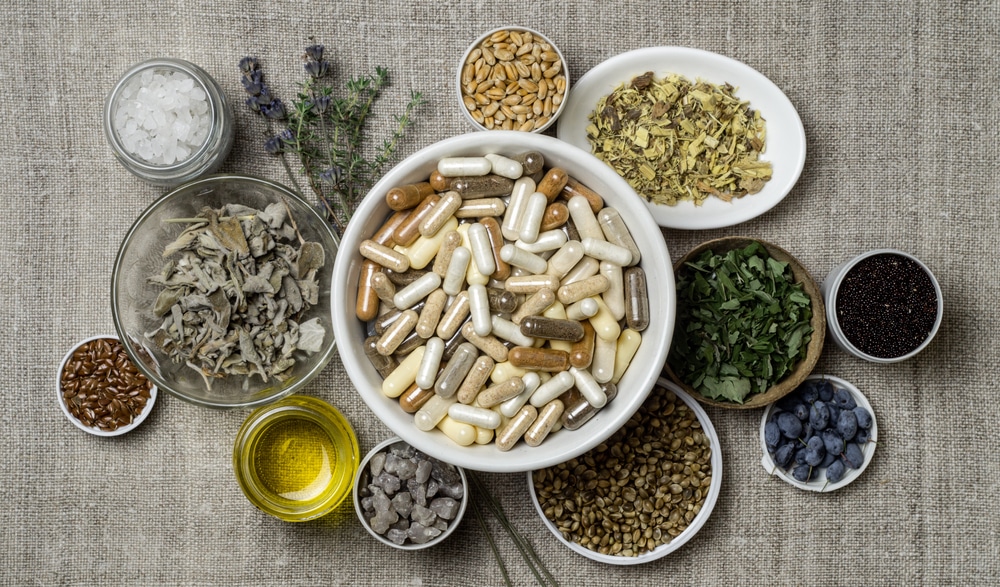 Assorted dietary supplements separated in bowls on table