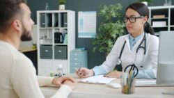 Medical provider consulting with patient about non-surgical body contouring treatment